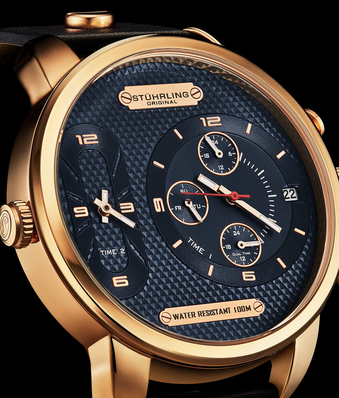 Luxury watch with gold case and blue dial on a black background